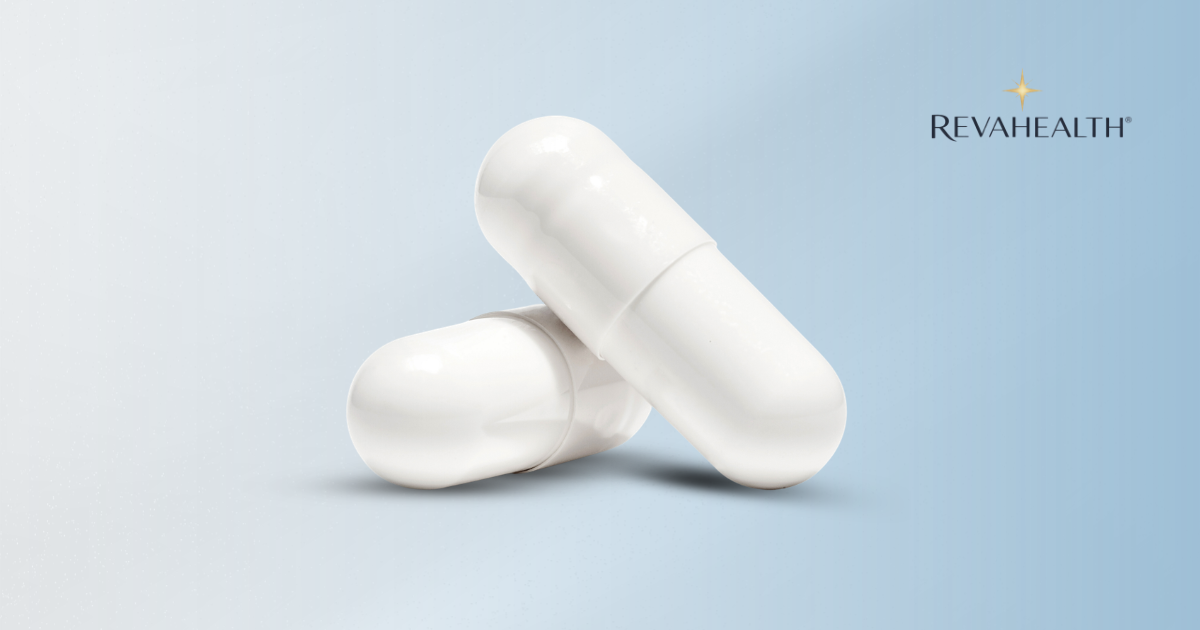 Two RevaHealth capsules resting on a pale blue surface beside the brand mark