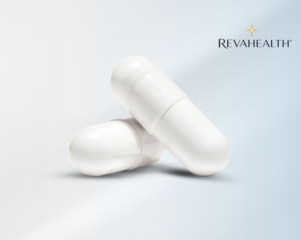 Two white RevaHealth capsules resting on a pale surface beside the brand mark